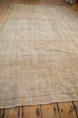 Low angle showing the soft, distressed texture of a vintage Turkish Oushak carpet.