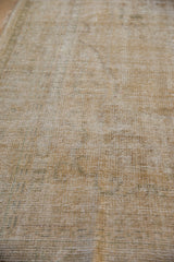 Distressed texture of a vintage Oushak carpet showing wear to the foundation and knot heads.