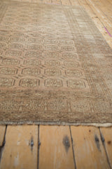 Distressed Afghani Bokhara rug border with faded geometric motifs, even wear, and fringe.