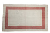 Distressed vintage Oushak carpet with creamy open field and faded raspberry triple border.