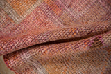 Textured distressed Kurd pile with abrashed raspberry, orange, and violet shades.