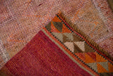 Hand-knotted vintage Kurd rug construction with geometric border in red, orange, and brown.