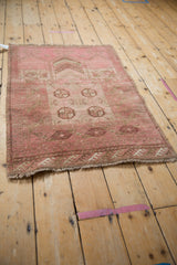 Distressed pile and geometric elephant footprint motifs on the vintage pink Daulatabad rug's fringed edge.