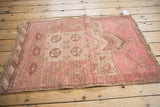 Distressed texture with camel, blush, and raspberry elephant foot print motifs on vintage Daulatabad rug.