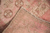 Blush pink distressed pile and hand-knotted foundation of a vintage Daulatabad rug.