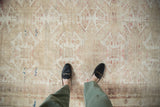 View of distressed vintage Kayseri rug showing heavy abrashes and faded floral motifs.