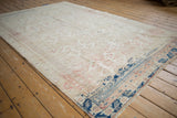 Distressed vintage Kayseri rug corner, showing heavy abrashes and navy blue border.