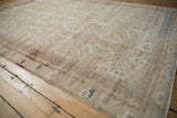 Distressed vintage Kayseri rug corner with heavy abrashes and muted floral motifs.
