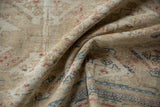 Distressed texture and faded floral blossoms in cream, rose, and navy blue.