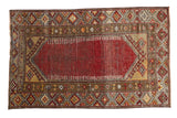 Vintage distressed Anatolian rug, worn cherry red field, saffron yellow and brown geometric borders.