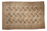 Distressed Ersari carpet, oversized floral guls in sand, dusty blue, and coffee brown.