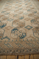 Textured vintage Ersari carpet detail with sand, camel, and dusty blue geometric guls.
