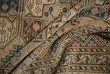 Distressed Ersari carpet fold revealing sand, coffee brown, dusty indigo patterns and even wear.