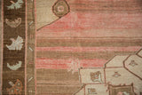 Distressed Kars carpet detail: heavily abrashed field, faded pink, brown tones, serrated leaf border.