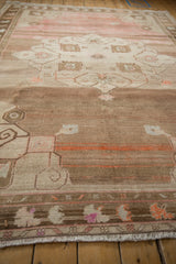 Heavily abrashed field with simplistic geometric relief and muted brown, pink, and orange tones.