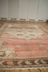 Vintage distressed Kars carpet with abrashed pale fuchsia field and even pile wear.