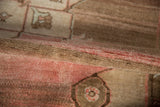 Textured view of vintage Kars carpet pile, showing muted brown, pink, and cream abrash.