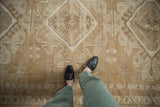Vintage distressed Oushak rug with even wear and geometric patterns, underfoot.
