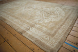 Vintage distressed Oushak carpet corner with geometric medallion, pawn motif border, and abrashes.