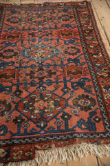 Detail of vintage Lilihan rug showing hand-knotted dusty raspberry pile, sapphire blue gul and vinery.
