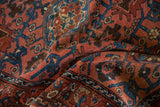 Textured folds of the vintage Lilihan rug, revealing sapphire blue vinery and dusty raspberry gul motifs.