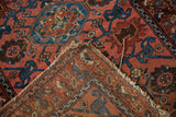 Lilihan rug fold reveals foundation, tattered edge, dusty raspberry, sapphire blue design.