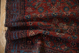 Hand-knotted vintage Malayer rug: cherry red and sapphire Herati pattern, isolated foundation showing.