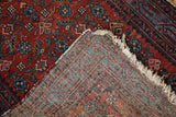 Vintage hand-knotted Malayer rug showing worn cherry red Herati pile and woven reverse.