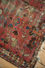 Heavily worn vintage Lilihan rug with exposed foundation, faded raspberry field, and geometric lotus blossoms.