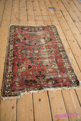Vintage Lilihan rug, faded raspberry field with allover palmettes, lotus flowers, and wear.