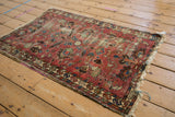 Vintage Lilihan rug corner detail: faded field with ornate serpent border and frayed fringe.