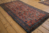 Vintage Hamadan rug's serrated leaves and blossoms in unusual dusty cochineal red and sapphire blue.