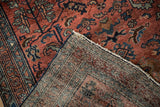 Vintage Hamadan rug corner, showing dusty red pile and detailed hand-knotted foundation.