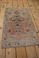 Distressed vintage Oushak rug corner, showing secured fringe and textured pile.