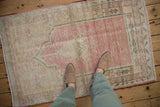 A personal view of the time-softened texture of a distressed pink and cream Oushak rug.