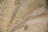 Vintage distressed Oushak rug pile, showing even wear and pale green, rose tones.