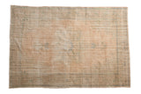 Distressed Vintage Oushak carpet with faded starburst medallion, palmette relief, dusty peach, green, and ivory. 7'2