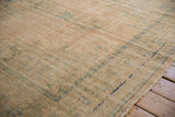 Textured pile of vintage distressed Oushak rug with visible foundation and muted peach.