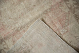 Reverse and worn pile of a Vintage Oushak rug, revealing beige and pale pink foundation.