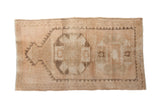 Distressed vintage Kurd rug with primitive geometric guls and mehrab in beige, dusty rose, charcoal.
