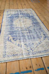 Decorative texture, worn cobalt blue and cream weave, on vintage Oushak rug side.
