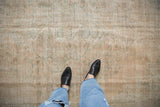 A close view of the distressed hand-knotted texture on a vintage Oushak rug in sandalwood and sea foam.