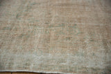 Textured low pile of a distressed Oushak carpet, revealing the underlying knot heads.