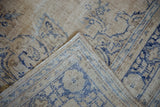 Distressed Oushak rug texture revealing exposed foundation and blue design.