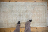 Vintage Distressed Oushak runner, worn ivory pile revealing foundation, with soft floral design.