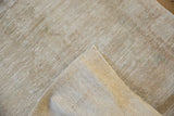 Distressed pile texture and visible foundation wear on the hand-knotted Oushak runner.