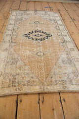 Textured vintage Oushak runner's distressed pile in soft gold and ivory patina.