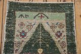 Vintage distressed Oushak prayer motif with dusty teal, mint, and beige tones and even pile wear.