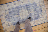 Faded cobalt blue and ivory pattern on distressed Oushak rug.