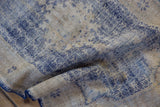 Vintage Distressed Oushak rug texture: cobalt blue geometric patterns worn to ivory foundation, with selvage.